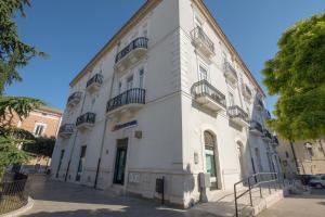 a white building with balconies on the side of it at Palazzo di Fazio Suites in San Severo