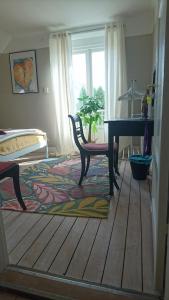 a living room with a table and a piano at The Garden Hill Hotel in Vallåkra