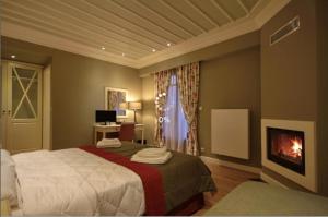 a bedroom with a large bed and a fireplace at Nerida Boutique Hotel in Dimitsana