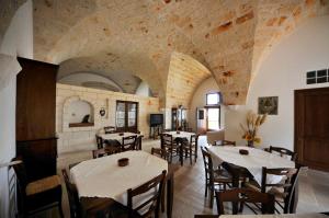 a restaurant with tables and chairs in a room at Masseria De Michele in Montalbano