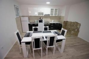 a kitchen with a table and chairs in a room at Apartment Garden in Blagaj