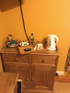 a wooden dresser with a jug on top of it at Chestnuts Bed and Breakfast in Whitehaven