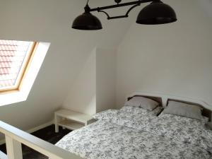 a bedroom with a bed and two lamps above it at Tkacka Home in Gdańsk