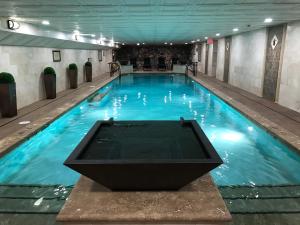 a large indoor swimming pool with blue water at Lewis & Clark Motel - Bozeman in Bozeman