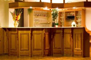 a bar with wooden cabinets and a counter at Hotel Zlatá vyhlídka in Benecko