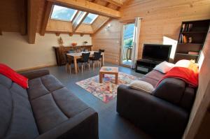 a living room with a couch and a table at Chalet La Merlerie in Morzine