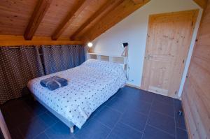 モルジヌにあるChalet La Merlerieの木製の天井が特徴のベッドルーム1室(ベッド1台付)