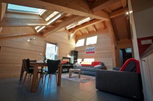 a living room with a table and chairs at Chalet La Merlerie in Morzine