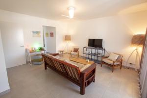 a living room with a couch and a television at Casa Leeward in Kralendijk