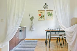 a kitchen with a table and chairs in a room at Apartment Barbora 2 in Ružomberok +24 photos