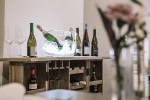 a table with bottles of wine and wine glasses at Boutique Hotel Pfauen in Schorndorf