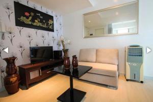 a living room with a couch and a television at Azure C6 Balcony Wifi near Mall Airport MULTIPL UNITS in Manila