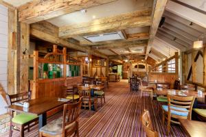 a restaurant with wooden walls and tables and chairs at The Victoria Hotel in Canterbury