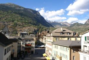 a view of a town with mountains in the background at Hotel du Pont in Brig