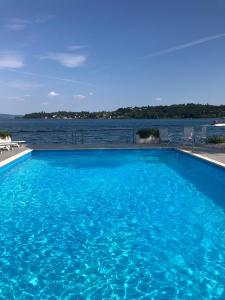a large swimming pool with a view of the water at Casa Vistabella in Salò