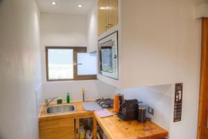 a small kitchen with a sink and a counter at Ruka Lobos in Pichilemu