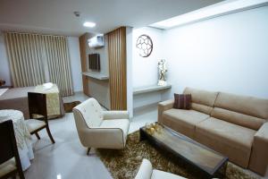 sala de estar con sofá y silla en Piloes Palace Hotel, en Mineiros