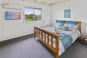 a bedroom with a bed and a window at Tanjil in Paynesville
