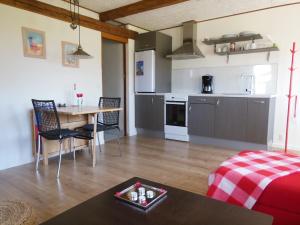 a living room with a table and a kitchen at Nyager Apartments in Ringkøbing