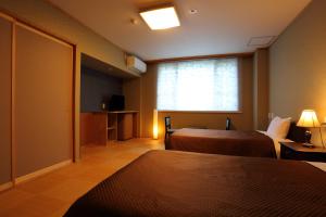 Postel nebo postele na pokoji v ubytování Hotel Oak Forest