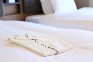 Postel nebo postele na pokoji v ubytování HOTEL SUI KANDA by ABEST