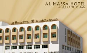 a large building with a sign on top of it at Al Massa Hotel in Al Buraymī