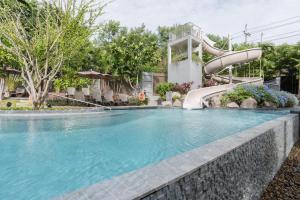 a swimming pool with a water slide in a resort at Unixx Pattaya by Alvin in Pattaya South