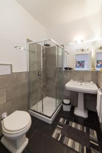 a bathroom with a shower and a toilet and a sink at Opera House in Palermo
