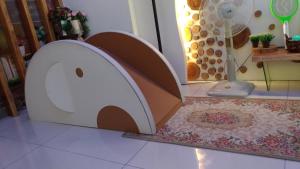 a dog house on the floor in front of a door at Romance Greece in Luodong