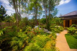 einen Garten mit üppigen grünen Pflanzen und einem Weg in der Unterkunft Chekesh Casa in Siquijor
