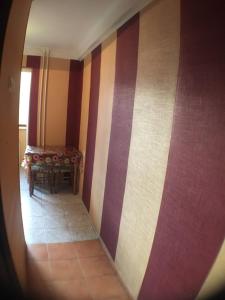 a hallway with colorful striped walls and a table at Apartment on Peremohy Ave 17 in Kyiv