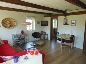 a living room with a red couch and a table at Nyager Apartments in Ringkøbing