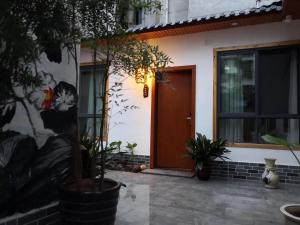 a front door of a house with a painting on the wall at Zhangjiajie Tingyutang Little Yard in Zhangjiajie