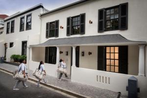 a group of girls walking down a street at More Quarters Hotel in Cape Town