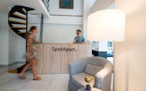a man standing at a reception desk in a room at Spot Apart in Athens