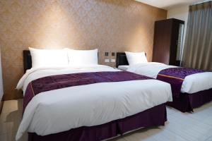 Postel nebo postele na pokoji v ubytování GIN JIAN Commercial Hotel