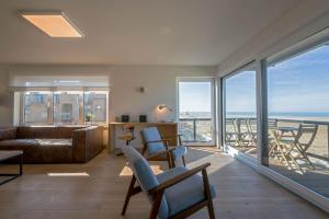 a living room with a view of the ocean at Seaview Zeebrugge in Zeebrugge