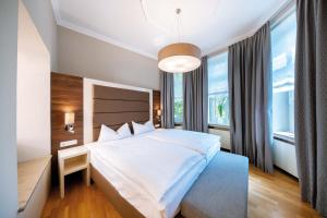 a bedroom with a large bed and a large window at Hotel Haus Delecke in Möhnesee