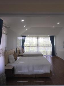 Giường trong phòng chung tại Valentine villas Phú Quốc