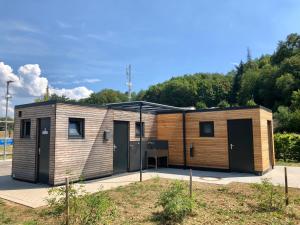 a small modular house with two doors on a lot at Campinghütte im SportErlebnisPark Allmersbach im Tal in Allmersbach im Tal