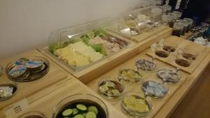 a table with a tray of food and plates of food at Adalbert Ecohotel in Prague