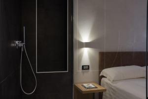 a bathroom with a shower with a bed and a shower at Hotel Doria in Genoa