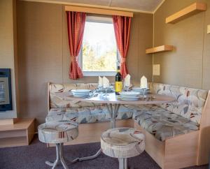 a living room with a table and a couch at Drumhoney Holiday Park in Enniskillen