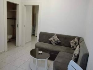 a living room with a couch and a table at Studio en plein zone touristique avec wifi, IPTV et Clim in Sousse +15 photos