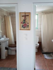 a bathroom with a toilet and a sink at Sea front Villas Danezis in Symi +80 photos