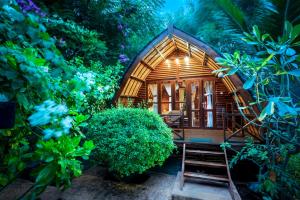 a small tree house in the middle of a forest at Manta Dive Gili Air Resort in Gili Air