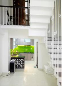 a kitchen with a green island in a room at Tin Tin Hue Hostel in Hue