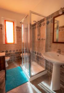 a bathroom with a shower and a sink and a toilet at Olivium in La Spezia