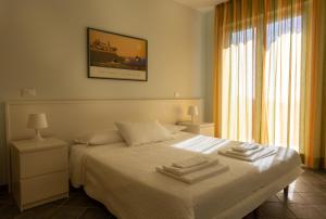 a bedroom with a bed with two towels on it at Olivium in La Spezia