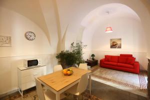 a living room with a red couch and a table at The House in Catania